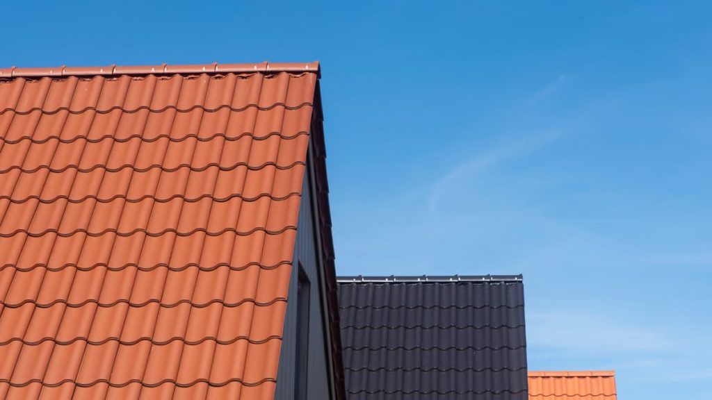 Vibrant rooftops contrasting with clear blue sky, showcasing architecture.